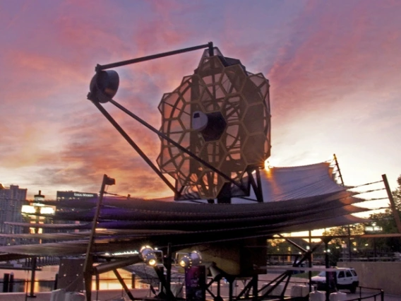 The sun rises behind the full-scale model of NASA's James Webb Space Telescope, as it sits at the Maryland Science Center in Baltimore's Inner Harbor.